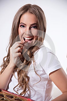 Happy woman eating chocolate