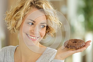 Happy woman eating donut