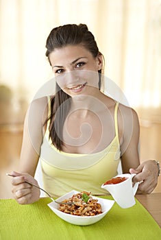 Happy woman eating pasta