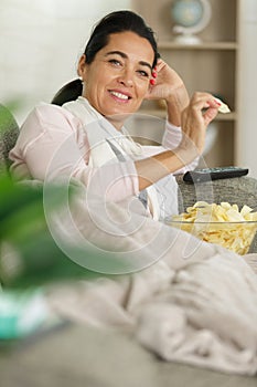 happy woman eating potato chips bowl