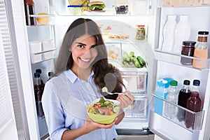 Happy Woman Eating Vegetable Salad