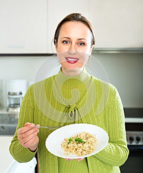 Happy woman eats rice