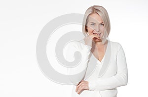 Happy woman emotionally posing in a studio. Happy woman in yellow bright sweater on white background