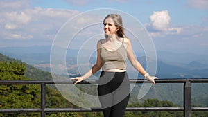 Happy woman enjoy fresh air and landscape view on sunny road trip