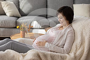 Happy woman enjoy healthy pregnancy relaxing at home