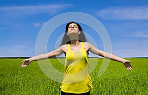 Happy woman enjoy sun in the field