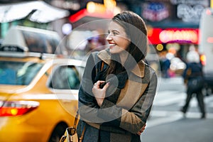 Happy woman enjoy the walk on winter time on New York City street and doing Christmas shopping. photo