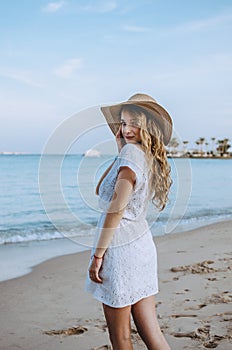 Happy woman enjoying beach relaxing joyful in summer by tropical blue water