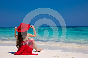 Happy woman enjoying beach relaxing joyful on white sand in summer by tropical blue water. Bliss freedom beach concept. Good life