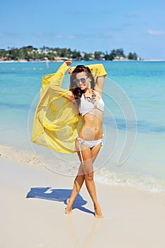 Happy woman enjoying at the beach, summer vacations concept