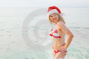 Happy woman enjoying Christmas vacation on the beach