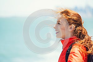 Happy woman enjoying freedom at ocean side on a boat