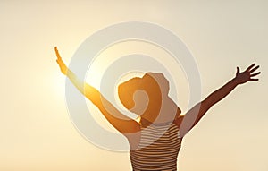 Happy woman enjoying freedom with open hands on sea