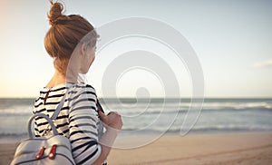 Happy woman enjoying freedom with open hands on sea