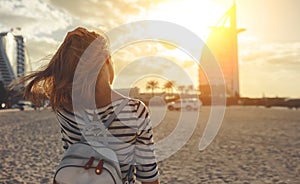 Happy woman enjoying freedom on sea at Burj Al Arab, hotel in Du