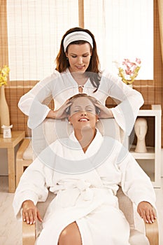 Happy woman enjoying head massage