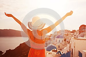 Happy woman enjoying her holidays on Santorini, Greece