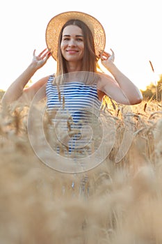 Happy woman enjoying life in field with flowers. Beauty nature, blue cloudy sky and colorful field with flowers. Outdoor