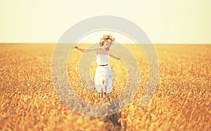 Happy woman enjoying life in golden wheat field