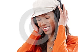 Happy woman enjoying music through earphones