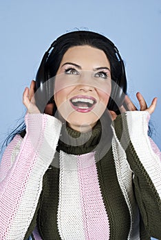 Happy woman enjoying music in headphones