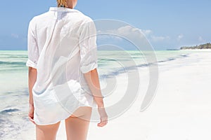 Happy woman enjoying, relaxing joyfully in summer on tropical beach.