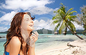 Happy woman enjoying sun on tropical beach