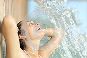 Happy woman enjoying under water jet in spa