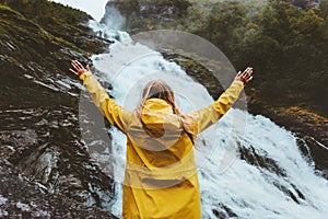 Happy woman enjoying waterfall view Traveling into the wild