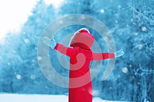 Happy woman enjoying winter snowy weather outdoors, season