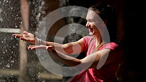 The Happy Woman Enjoys the Falling Water Drops. Water is the Source of Life.