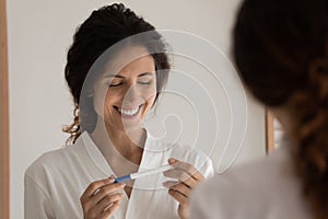 Happy woman excited about positive pregnancy test result
