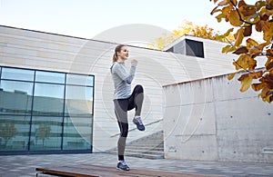 Happy woman exercising on bench outdoors