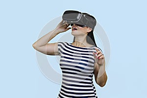 Happy woman is experiencing virtual reality in headset.