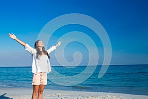 Happy woman with eyes closed at the beach