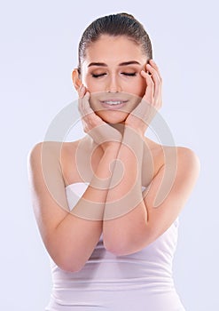 Happy woman, eyes closed and hands on face for beauty, glow and wellness with dermatology for skin on white background