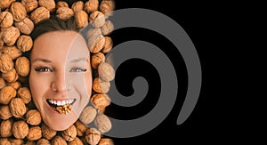 Happy woman face with perfect smile on a walnuts background with copy space