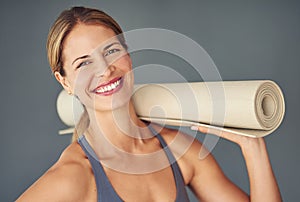 Happy woman, face and portrait smile with yoga mat for fitness, zen workout or exercise against a grey studio background