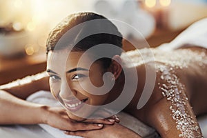 Happy woman, face and portrait at spa for back massage, skincare or beauty in body treatment. Calm female lying on bed