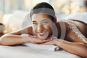Happy woman, face and portrait at spa for massage, skincare or beauty in relax body treatment. Calm female lying in