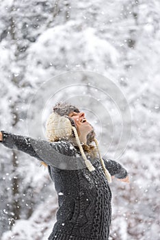 Happy Woman at Falling Snow with Open Arms