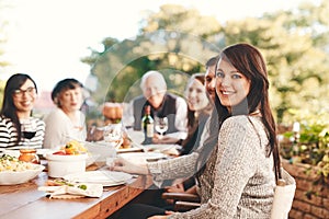 Happy woman, family and food outdoor at patio table for thanksgiving or Christmas celebration wine, alcohol and meal for
