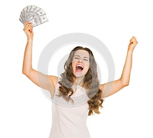 Happy woman with fan of dollars rejoicing success