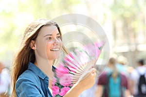 Happy woman fanning in the street photo