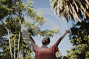 Happy woman feeling free in the park