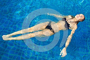 Happy Woman Floating In Pool