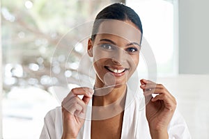 Happy woman, flossing and dental for teeth whitening, mirror or reflection in bathroom for morning routine. Oral hygiene