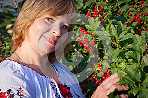 Happy woman with flower relaxes in the grass with a flower.