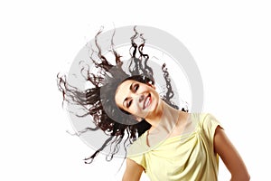 Happy woman with fluttering curly hair isolated