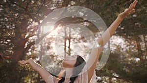 Happy woman in forest enjoying nature. Cute young girl walking outdoors